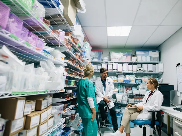 People in healthcare office stockroom