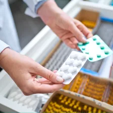 Image of person holding blister packs.